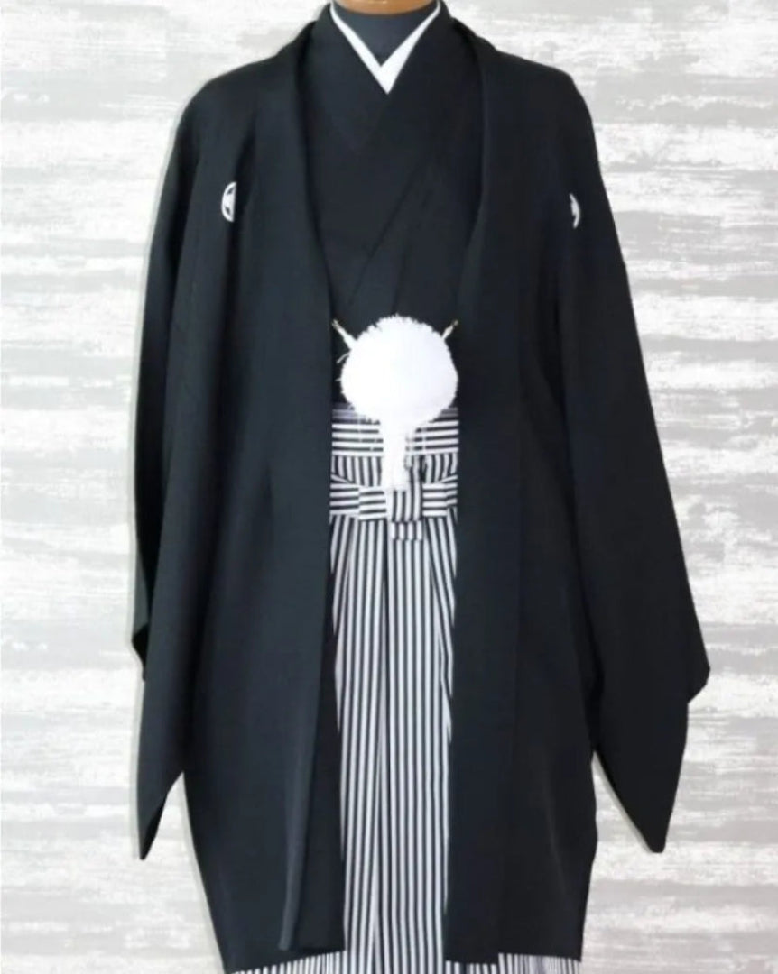 仙台のフォトスタジオQnNeによる黒の五つ紋付き羽織袴スタイル。白黒の縞袴と白房が特徴で、結婚式・前撮り・成人式などフォーマル撮影に最適な男性用伝統和装。